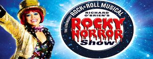 Banner advertising The Rocky Horror Show, with a red haired lady on the left dressed in gold sequins and a gold top hat.